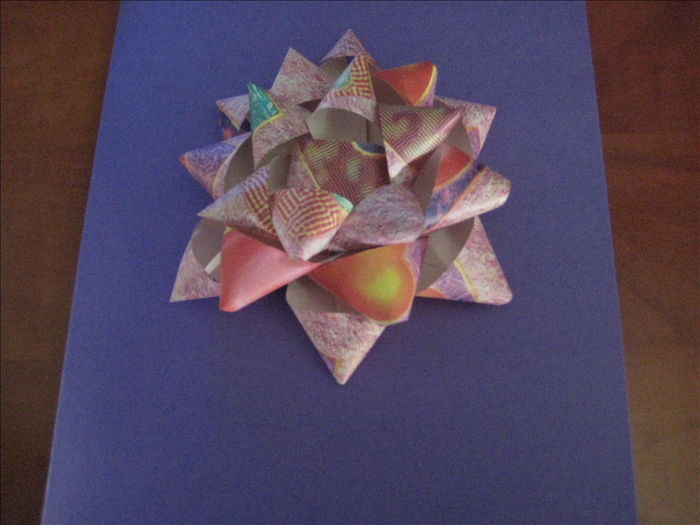 How to make a bow for a present from strips of paper.